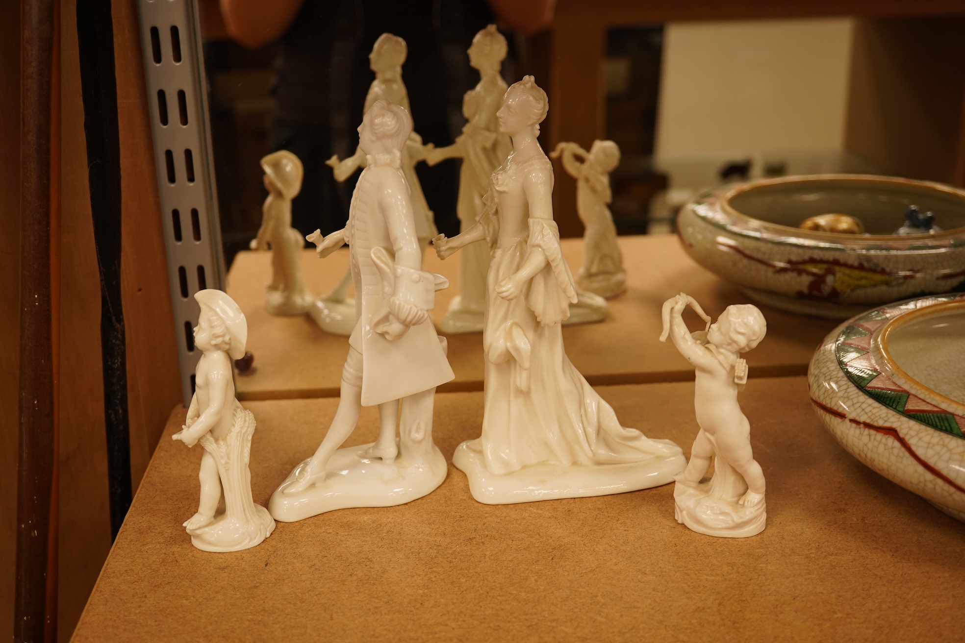 Two Nymphenberg white glazed figures, after Bustelli and two similar cherubs (4) figure 19 cm high